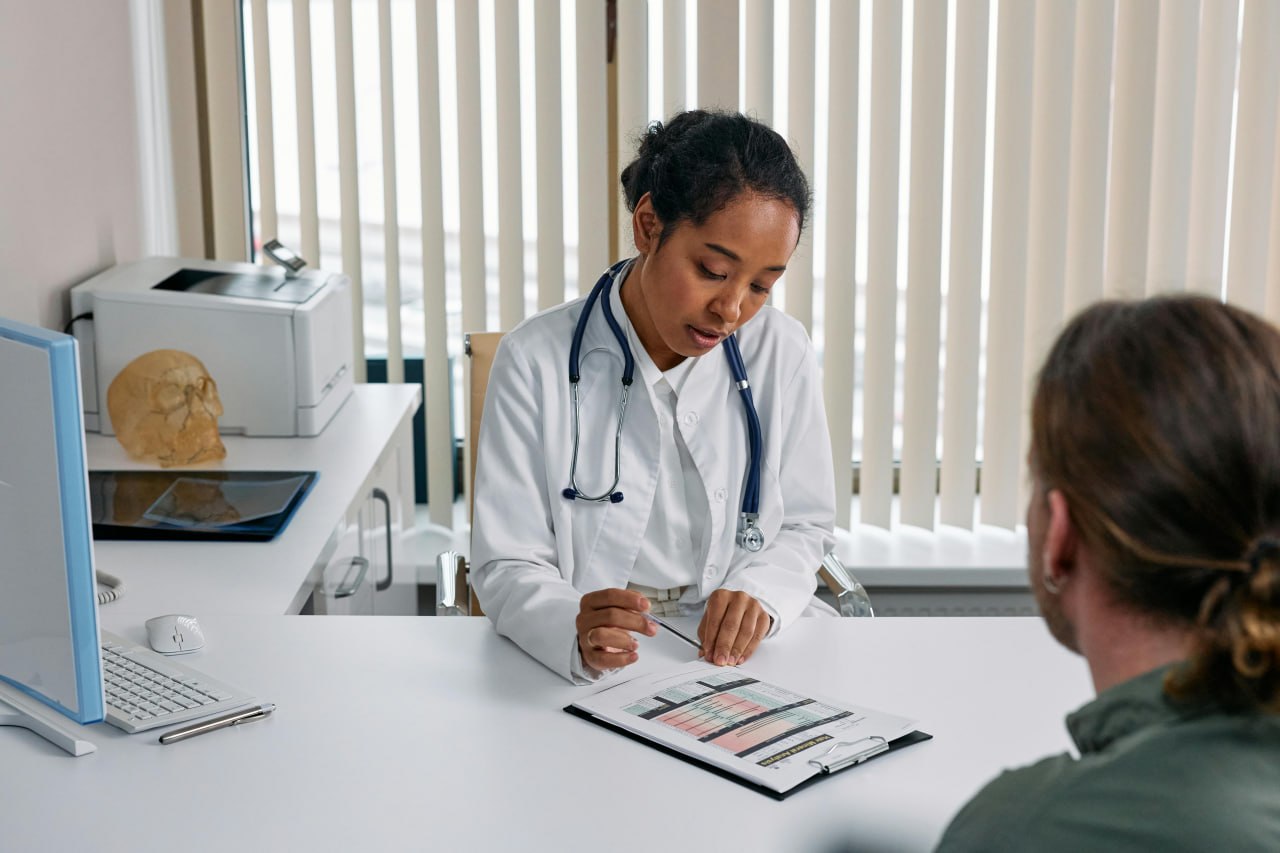 A doctor reviewing tracked health data with a patient