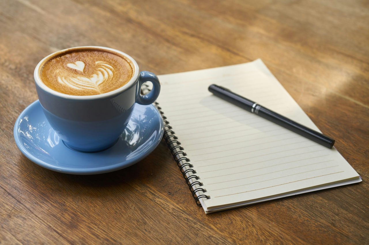 A notebook and pen with coffee — the simple appeal of analog tracking